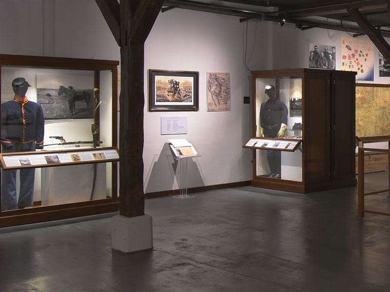 A gallery with museum exhibits inside the Reed Museum and 2d Regiment of Dragoons Heritage Center.